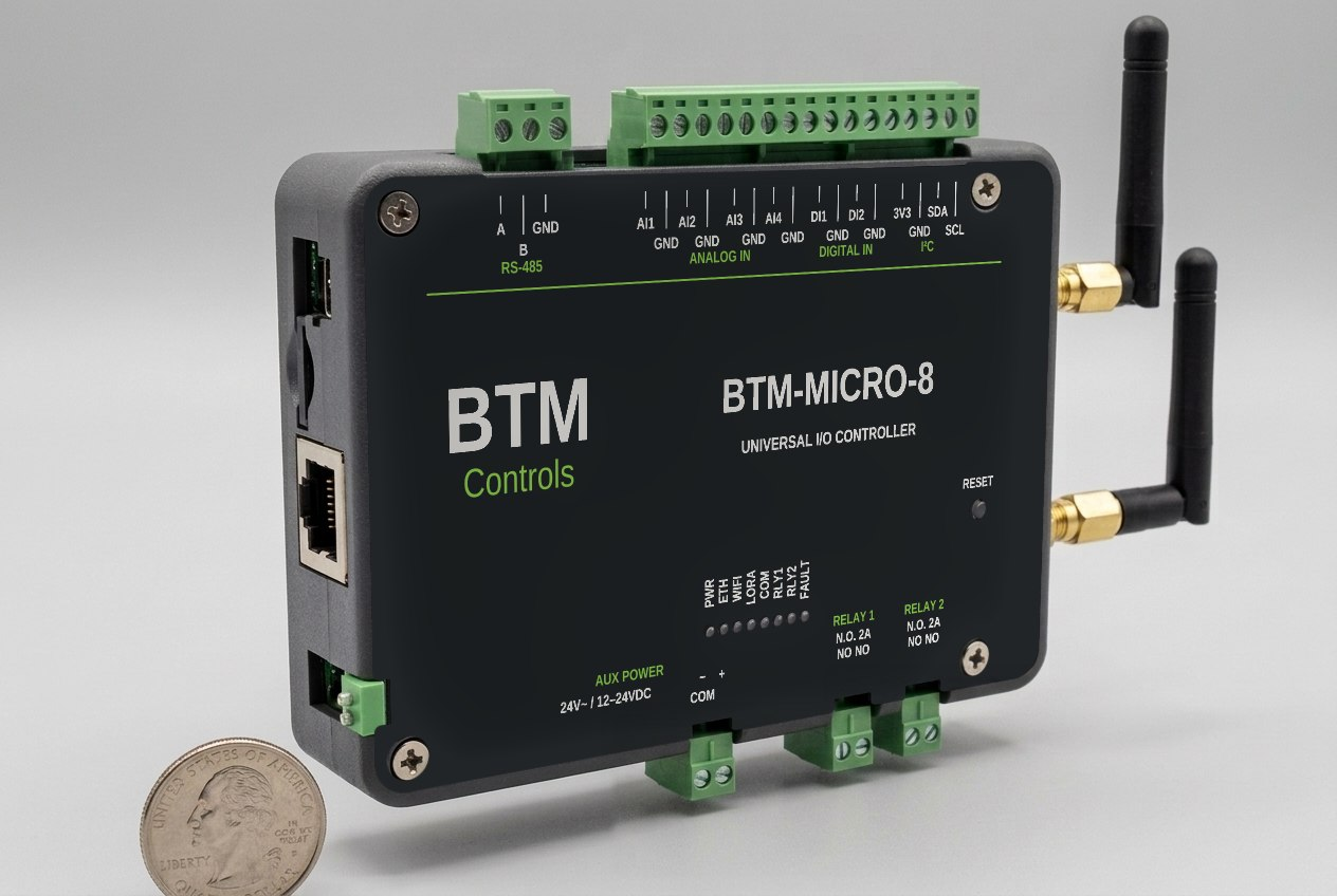 BTM-MICRO-8 universal I/O controller with dedicated Wi-Fi and LoRaWAN antennas beside a United States quarter for scale